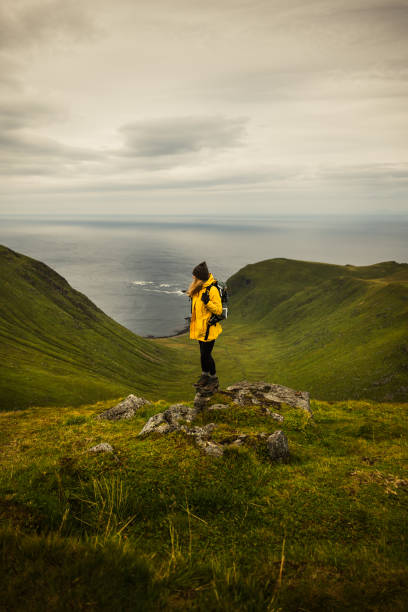 istock An Adventurous Hiker Standing Proudly on a Scenic Mountain Peak Overlooking Breathtaking Views 2177399892