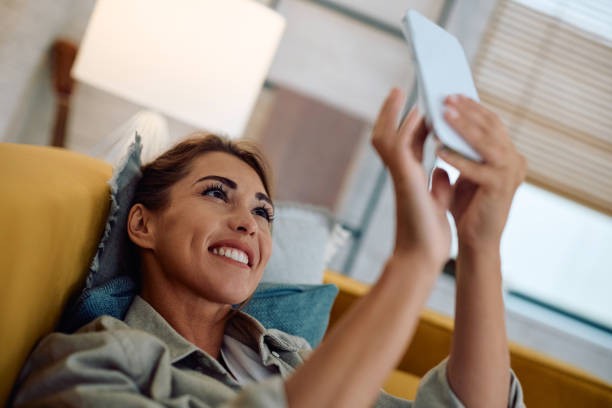istock Young happy woman taking selfie while relaxing at home. 2177400277