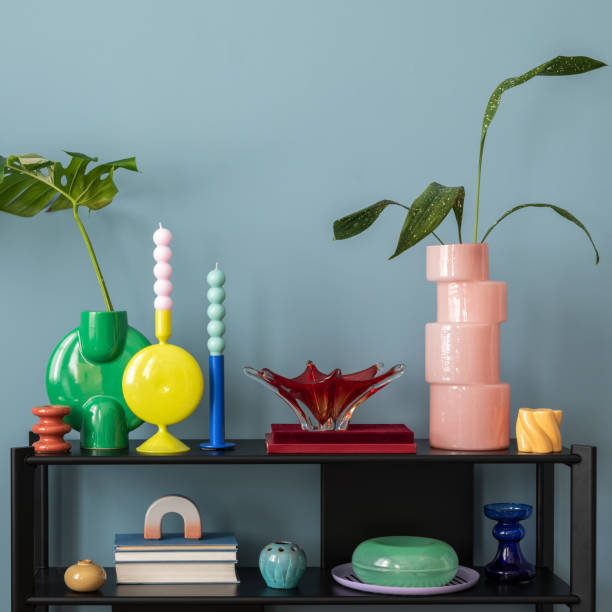 istock Colorful composition on blue wall with black shelf, design accessories, and decorations  vases with leaf, candels and copy space. Home decor. Template. 2177402126