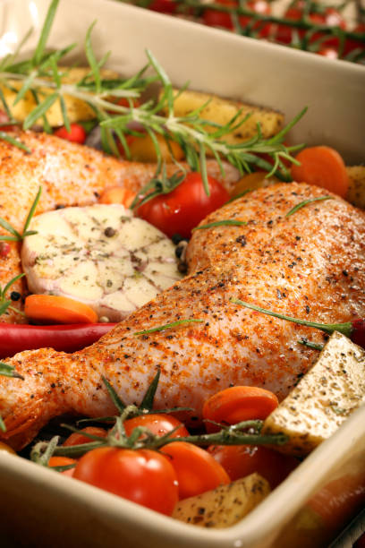 istock Chicken legs with vegetables and herbs ready for roasting 2177405513