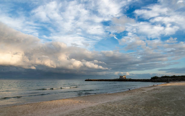 Dramatic sky over Pomorie town and fishermen on the bridge. Burgas province, Bulgaria, Eastern Europe.