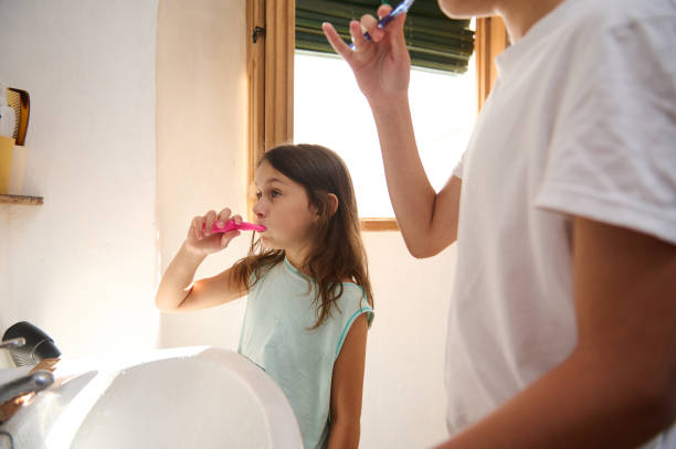 istock Children brushing teeth together in morning routine 2177407437