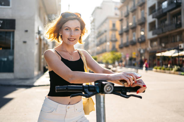 istock Young woman using e-banking on a smartphone in the city 2177407651