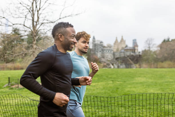 istock Two Men Jogging in the Park on a Cloudy Day 2177410166