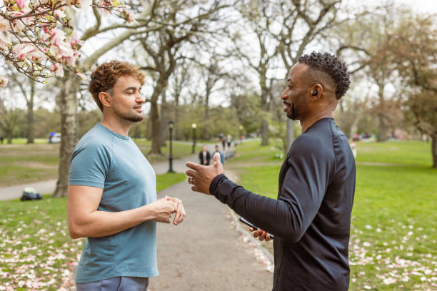 istock Two Men Engaged in Conversation in Park During Daytime. Central Park, NYC 2177410194