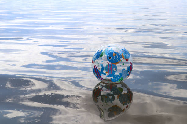 istock Beach ball on the water surface with place for text. 2177411662