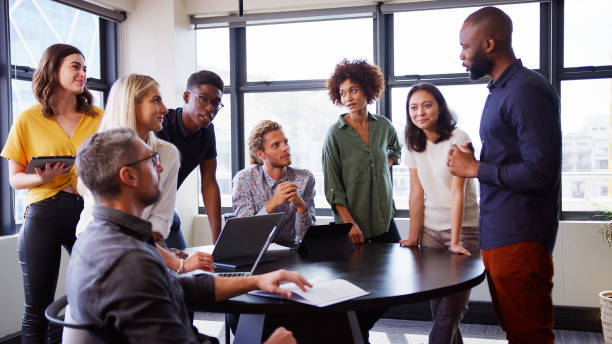 istock Multi-Cultural Business Team Meeting And Collaborating Around Table In Modern Office Together 2177411973