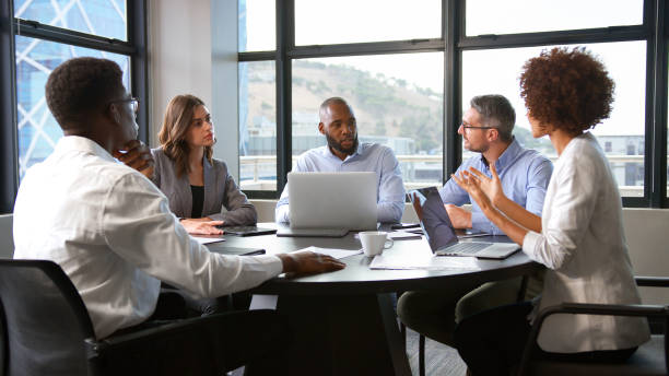 istock Multi-Cultural Business Team Meeting Collaborating Sitting Around Table In Modern Office Together 2177412812