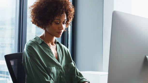 istock Young Businesswoman Sitting At Desk Working At Computer In Modern Office 2177413449