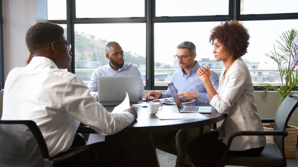 istock Multi-Cultural Business Team Meeting Collaborating Sitting Around Table In Modern Office Together 2177413739