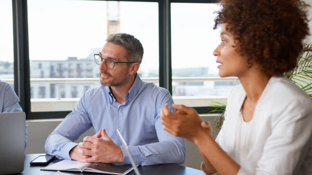 istock Business Team Meeting Collaborating Sitting Around Table In Modern Office Together 2177414224