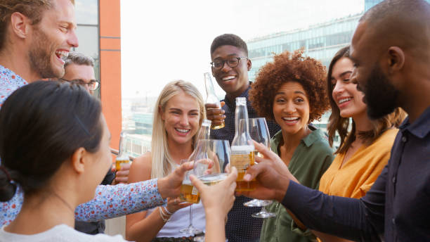 istock Multi-Cultural Business Team Celebrating Outdoors For After Work Drinks On Office Rooftop Or Bar 2177414324