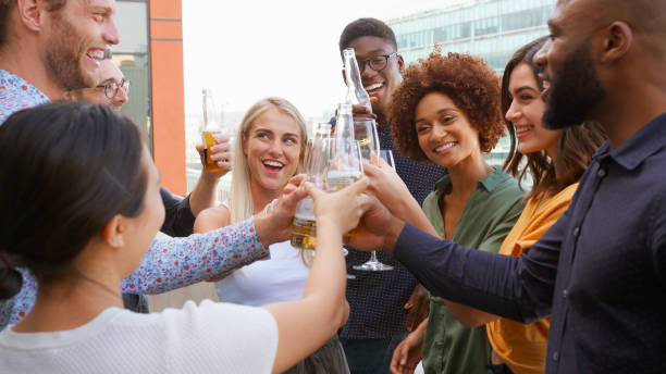 istock Multi-Cultural Business Team Celebrating Outdoors For After Work Drinks On Office Rooftop Or Bar 2177414475