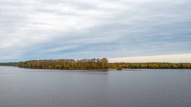istock Atmospheric autumn background with a river and a distant river bank with a forest in autumn colors. 2177414572