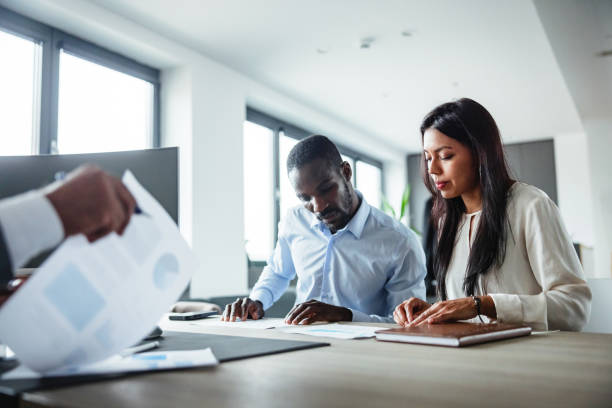 istock Black and Latin Business Professionals Collaborating in Office 2177416111