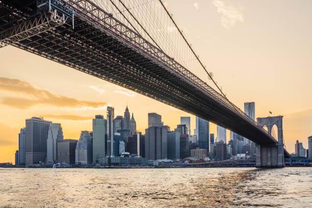 istock Brooklyn bridge stretching over east river at sunset with manhattan skyline in background 2177423385
