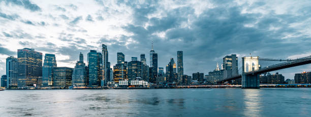 istock Lower manhattan and brooklyn bridge illuminating during cloudy dusk 2177423389