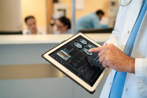 istock Close-up of physician using tablet to explain test results to a patient 2177423581