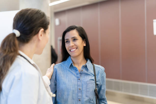 Doctor talking with expectant patient in hospital hallway