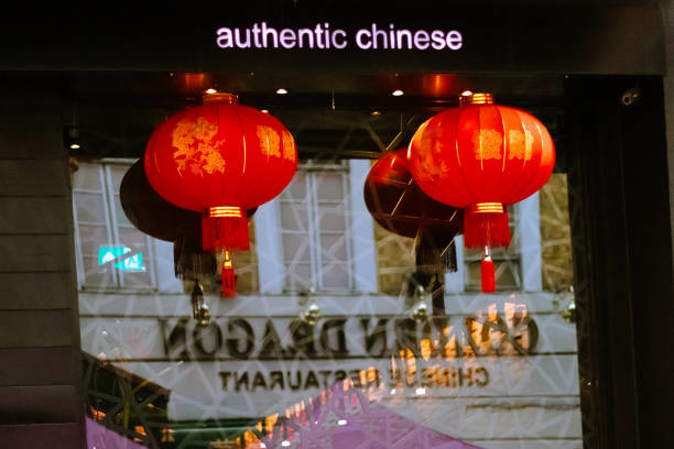 London, England, May 12 2023: China Town London restaurant front window with two Chinese lamps