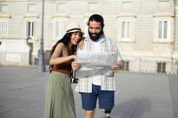 istock Smiling couple consulting city map on vacation 2177426360