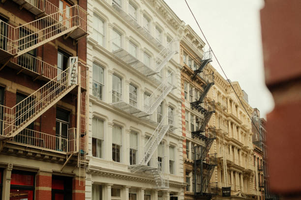 Old and renovated buildings are showing their fire escapes creating a pattern in soho, new york city