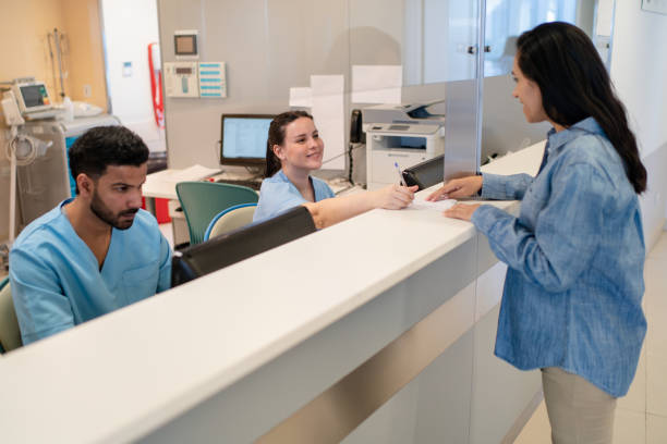 istock Front desk receptionist helping pregnant patient filling corm 2177429173