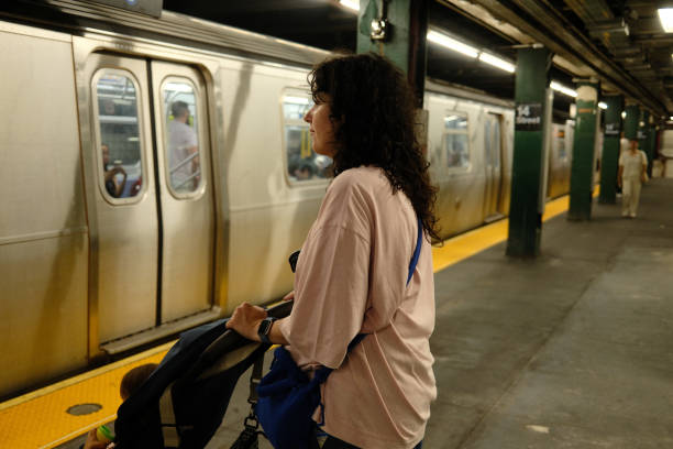 istock Mother waiting for subway with baby in stroller 2177429296