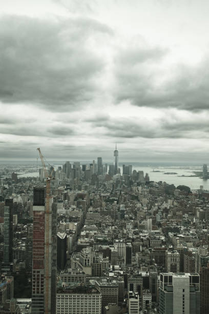 istock Construction crane towering over new york city skyline under cloudy sky 2177430932