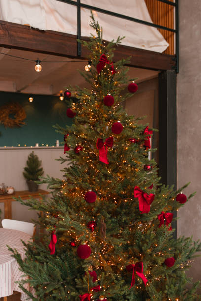istock Christmas tree with red bows and lights on it 2177436456