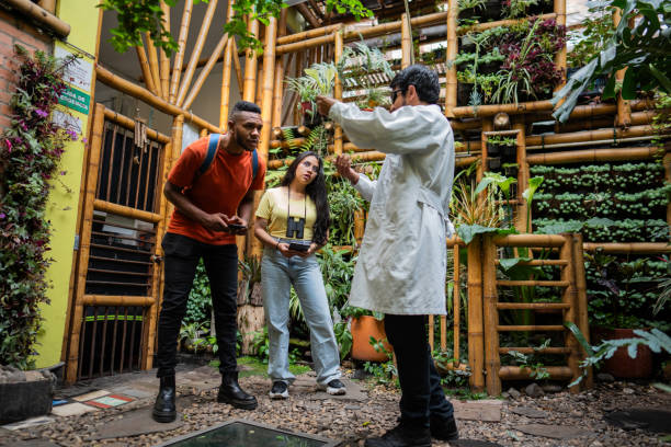 istock Biologist analyzing plants and students using mobile phone and digital tablet in a plant nursery 2177440110