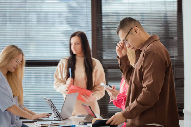 istock Group of people are sitting around a table with laptops 2177441140
