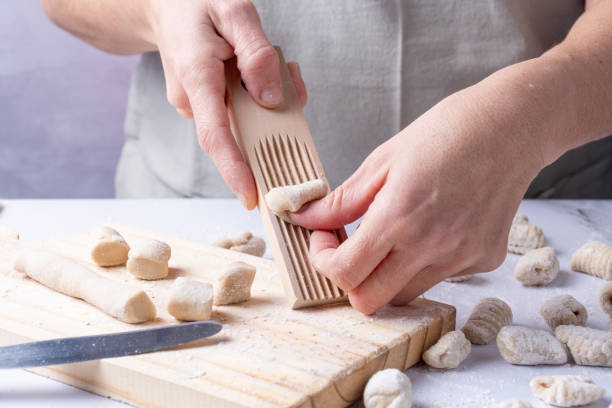 istock Human hands shaping the gnocchi with a wooden utensil. 2177442802