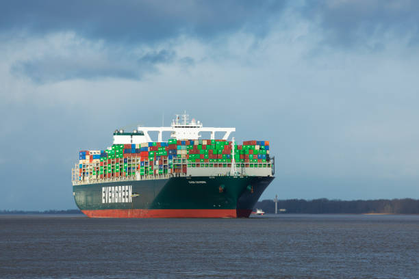Stade, Germany - January 12, 2021: Container ship EVER GOVERN on Elbe river heading to Hamburg. The vessel is operated by EVERGREEN Marine and sails under Panamese flag. Marine and sails under Panamese flag.
