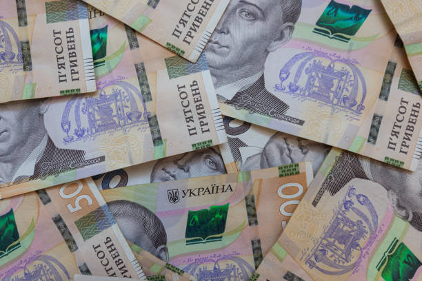 istock dollar and  500 hryvnyas banknotes background 2177446950