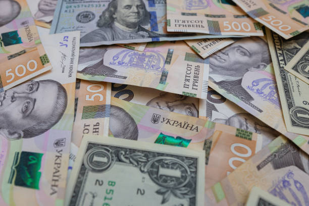 istock dollar and  500 hryvnyas banknotes background 2177446957