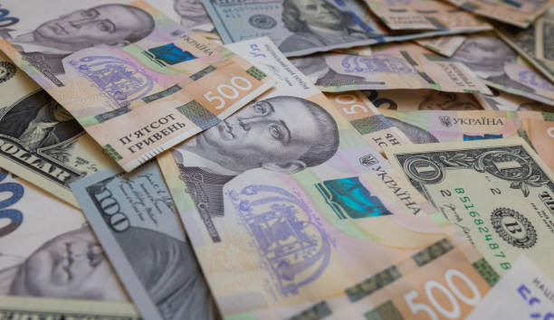 istock dollar and  500 hryvnyas banknotes background 2177446958