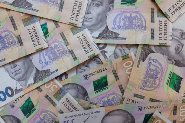 istock dollar and  500 hryvnyas banknotes background 2177446977
