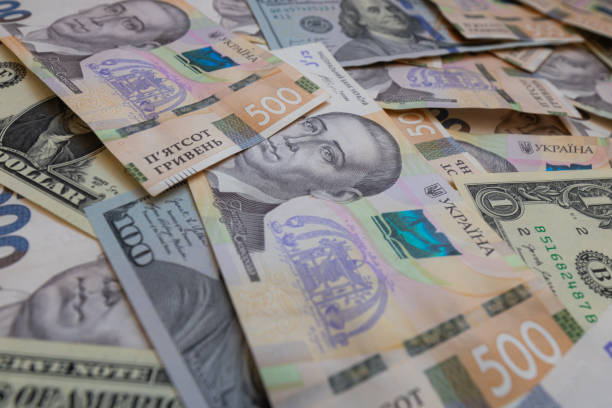istock dollar and  500 hryvnyas banknotes background 2177446978