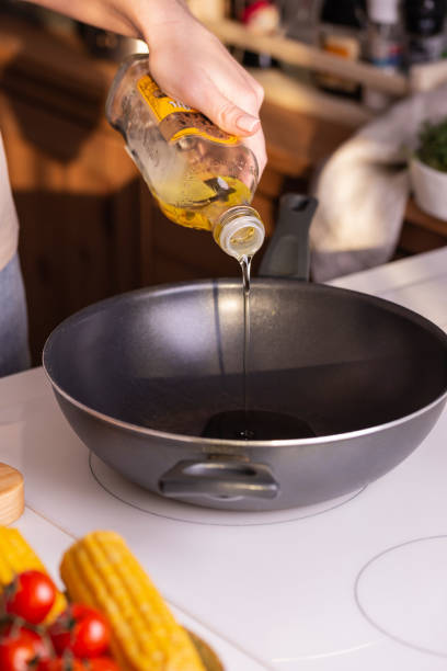 istock pour vegetable oil into a frying pan 2177447132