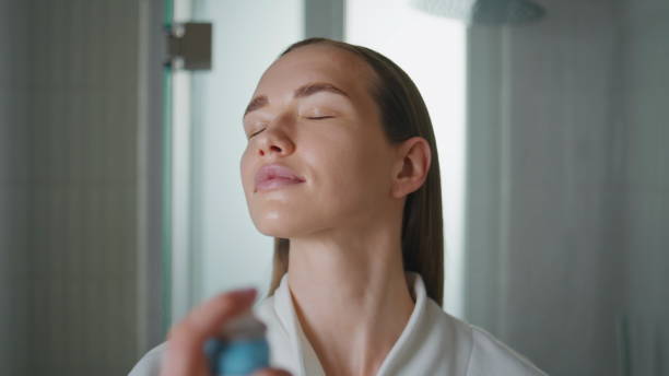 istock Woman spraying face water in bathroom closeup. Pretty lady using moisturizer 2177447350
