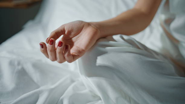 istock Closeup hands practicing yoga in sunlight. Serene girl meditating on cozy bed 2177448005