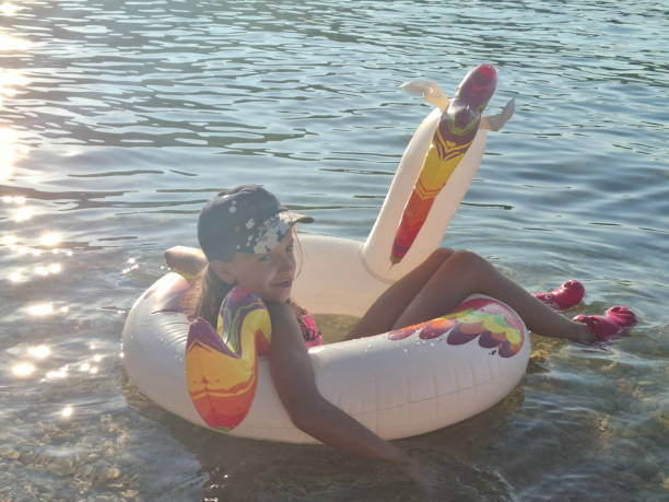 Beautiful girl enjoying summer vacation swimming in sea.