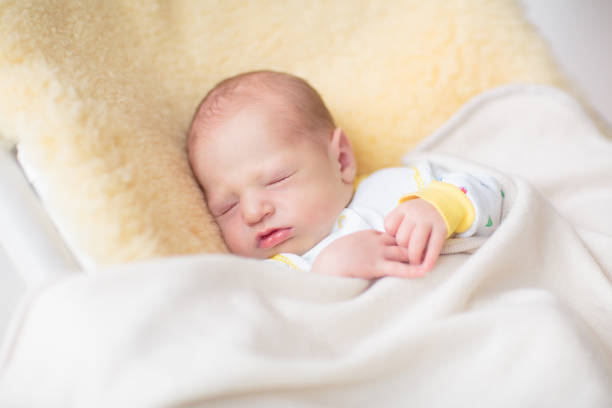 istock Little baby on white bed 2177449812