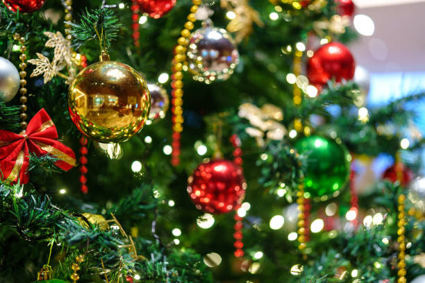 istock A beautifully decorated Christmas tree glows with festive ornaments, set against bokeh background of soft, twinkling lights. 2177450778
