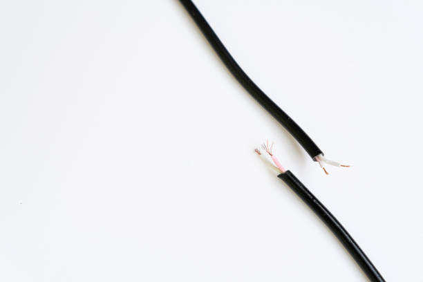 Two ends of a torn cable with a copper core, on a white background. Broken cable requiring repair. Disconnection concept