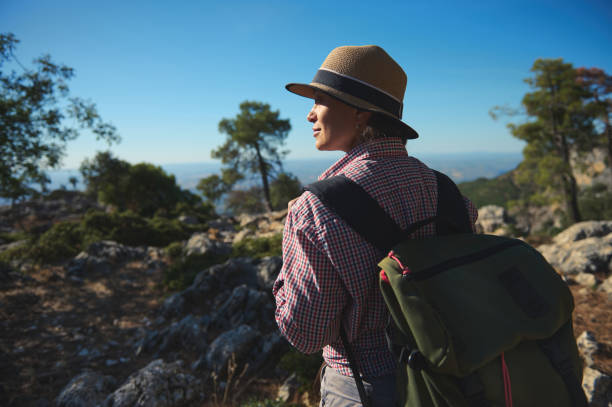istock Woman exploring nature with backpack under clear blue sky 2177451643