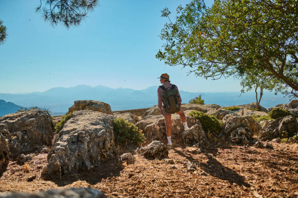 istock Adventurous hiker explores rocky mountain trail with scenic views 2177451653