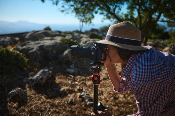istock Photographer exploring nature with camera on tripod outdoors 2177451699