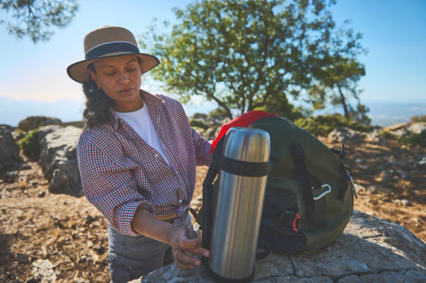 istock Woman preparing for a hike with a backpack in nature 2177451771